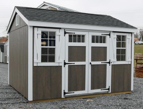 Pine Creek 10x12 HD New England Peak with Driftwood Polyurethane walls, White shutters White trim, and Charcoal shingles